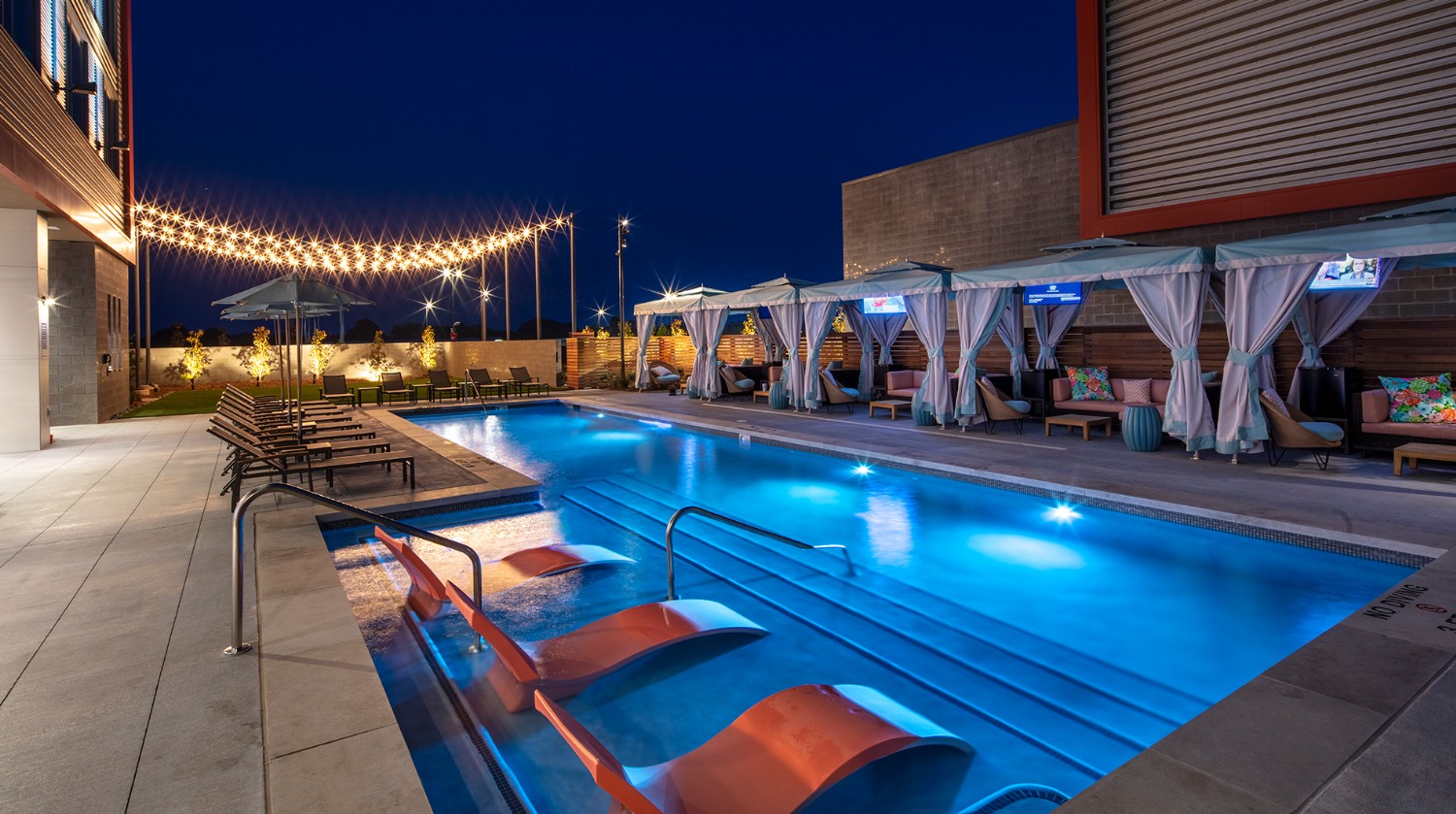 A night view of the pool and cabana outside the Oaklawn hotel