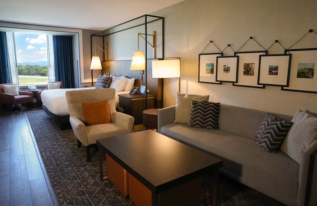 A room at the Oaklawn hotel featuring a living room, bed and trackside view